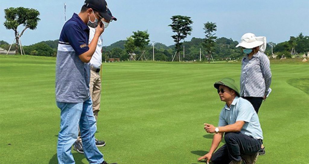 Men on working on a golf course.